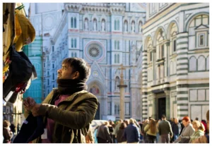 A hat merchant carefully arranging his articles